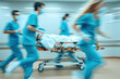 © Anna - Blurred motion of medical staff rushing a patient on a gurney through a hospital corridor.