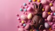 Easter composition - chocolate bunny, colored eggs and candies on pink paper background, top view