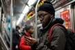 young african man use mobile phone in subway