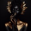 Fashion portrait of beautiful african woman with golden make-up and gold feathers on black background.