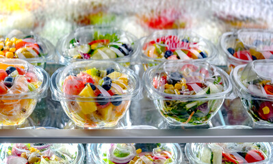 Wall Mural - Boxes with fruit and vegetable salads in a commercial fridge