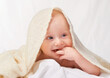 © T. Rose/peopleimages.com - Baby, suck and finger for relax, comfort or sleep in nursery in studio on white background. Happy, young child and hand on blanket for peaceful nap time for health, rest and childhood development