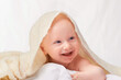 © T. Rose/peopleimages.com - Baby, laugh or blanket to play, relax or comfort in funny, goofy and nursery on white background. Happy, young child or linen for peaceful rest for health, wellbeing or childhood development