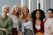 © gstockstudio - Group of happy mature women looking at camera while standing in the office together