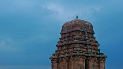 Wall Mural - View of ancient shiva temple(upper Shivalaya) with water reflection in foreground at Badami, karnataka, India.