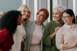 © gstockstudio - Group of happy mature women bonding and smiling while standing in the office together