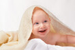 © T. Rose/peopleimages.com - Baby, smile or towel to play, relax or laugh in nursery at bath time in studio on white background. Happy, young child or blanket for peaceful rest for health, hygiene or childhood development