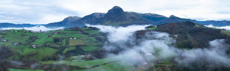 Wall Mural - Aerial drone view of the winter landscape around the town of Gainza and Amezqueta and the Txindoki Mountain. Aralar Mountain Range. Goierri region. Gipuzkoa. Basque Country. Spain. Europe