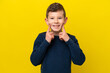 Little caucasian boy isolated on yellow background smiling with a happy and pleasant expression