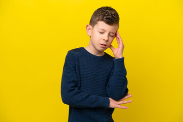 Wall Mural - Little caucasian boy isolated on yellow background with headache