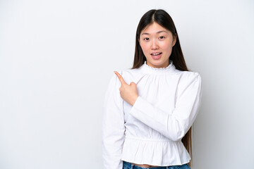 Wall Mural - Young Chinese woman isolated on white background surprised and pointing side