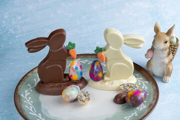 Wall Mural - Milk and white chocolate bunnies next to small chocolate eggs_3.