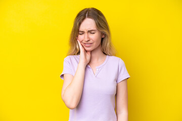 Wall Mural - Blonde English young girl isolated on yellow background with toothache