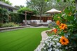 Backyard garden scene with artificial grass A cozy patio And a vibrant flower bed
