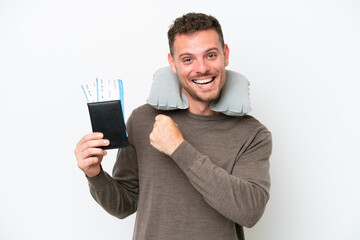 Wall Mural - Young caucasian man holding a passport isolated on white background celebrating a victory