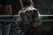 © Nii_Anna - Detailed photo of a weightlifter's hands gripping a barbell, chalk dust visible, focus on strength and preparation, gym background