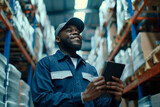 Fototapeta Panele - happy employee standing in warehouse using a tablet