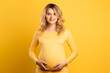 Young pretty blonde Pregnant girl over isolated colorful background
