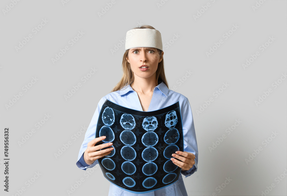 Young woman with brain concussion and MRI scan on light background