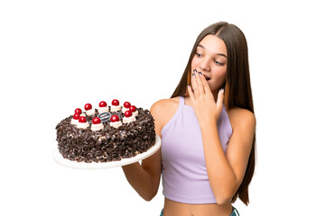 Canvas Print - Teenager caucasian girl holding birthday cake over isolated background with surprise and shocked facial expression