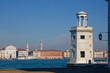 VENICE, ITALY, February 2, 2024 : Lighthouse of San Giorgio Maggiore and the city of Venice on the other side of the lagoon