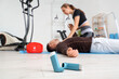 © Pixel-Shot - Asthma inhalers and trainer giving man first aid in gym, closeup