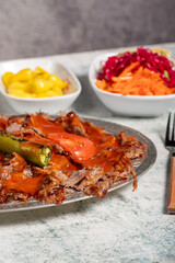 Wall Mural - iskender kebab. Traditional Turkish cuisine flavor with tomato sauce and butter. iskender kebab on gray background