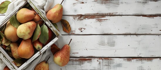 Poster - A wooden basket filled with fresh organic pears, complete with leaves, sits atop an old white wooden table. This image captures the essence of autumn fruit harvest.