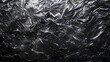 Abstract texture of crumpled plastic on dark background.