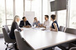 © fizkes - Five diverse office employee listen to male teammate, boss or leader make speech, share ideas, business vision, solutions, sales results at formal meeting briefing with workmates in modern board room