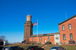 United States flag waving in the breeze next to the north tower of the historic Navesink Twin Lighthouses in Highlands, New Jersey, USA -18