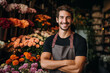 © Darya - A handsome young male florist gardener posing in greenhouse. Small business owner in flower shop