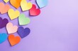 Multiple hearts in rainbow hues against a purple surface. Rainbow Hearts on Purple Background