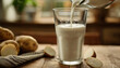 Lifestyle photo of potato milk, vegan potato milk in a glass and potatoes on a brown kitchen background, plant based milk, vegan food