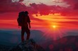 © Adriana - The mountaineer is on the summit contemplating the landscape. man standing on top of a mountain with a backpack on his back and a sunset in the background behind him, with a red sky and orange clouds