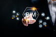 © Pakin - BIM, Building information modeling technology concept. BIM industry. Businessman touching with BIM icons on virtual screen.