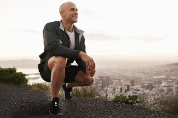 Canvas Print - Happy man, mountain and fitness with view of city for workout, exercise or training in nature. Young male person or athlete with smile for running, break or rest on road, street or outdoor cliff