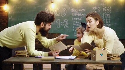 Fototapete - Boy from elementary school. Family with little child boy reading book In playroom class. Happy cute clever boy. Child ready to answer with chalkboard on background. Ready for school.