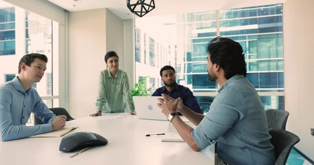 Poster - Group meeting of four young professional team members gather in conference room in skyscraper office share opinion, search solutions engaged in corporate briefing event in company workspace. Teamwork