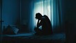 © buraratn - Lonely man silhouette sitting on the bed feeling depressed and stressed in the dark bedroom, Depression and anxiety disorder concept