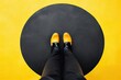 Comfort Zone. Path to Career Success Within Walls of Comfort. A Black Shoe Stands in a Yellow Circle on Asphalt Floor. Business Concept