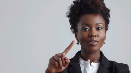 Poster - A woman in a business suit pointing to the side. Suitable for business presentations