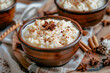Rice pudding with cinnamon. Traditional seasonal tasty Christmas dessert, served in vintage dishes.