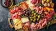 Top view of a charcuterie board laden with an assortment of cured meats, artisanal cheeses, olives, nuts, and dried fruits, arranged elegantly on a wooden platter