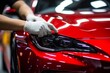© Yuliia - Professional unrecognizable Caucasian specialist male man guy worker master wrapping installing protective film vinyl foil new red sport car automobile transport paint protection indoors salon service