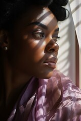 Wall Mural - woman portrait with brow arching in her hand as she looks at a window