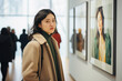 Woman looking at a portraits gallery.