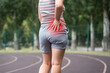 Pain in the hip during training, muscles cramped, massage on a sports ground after workout