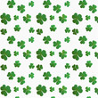 © TheBunditt - The seamless pattern of green clovers on a white background