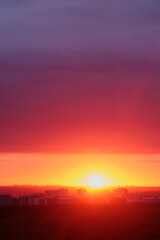 Wall Mural - Sunset paints the evening sky with vibrant red clouds.